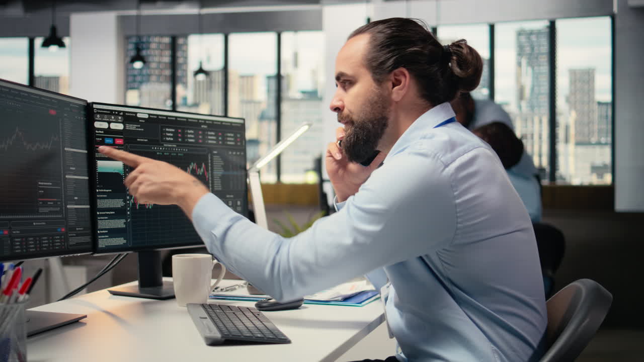 Investment consultant talking in telephone call with client, reviewing portfolio