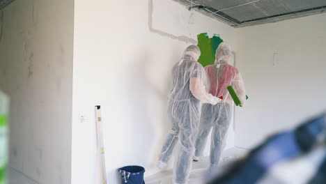 woman and guy in workwear dance lambada coming into room