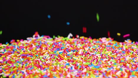 vibrant sprinkles cascade against a dark background