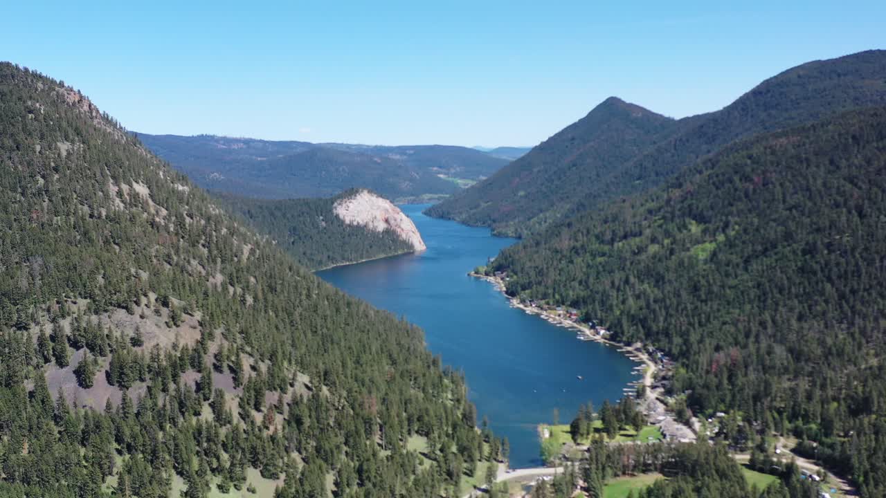Nature's Oasis: Embrace the Serenity of Paul Lake in Kamloops on a Sunny Day, Amidst Majestic Forest Mountains