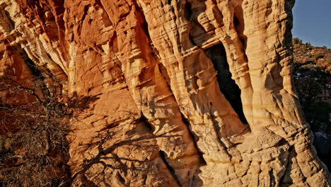 stunning aerial footage of a remote natural arch as the rising sun casts a warm glow near kanab, utah.