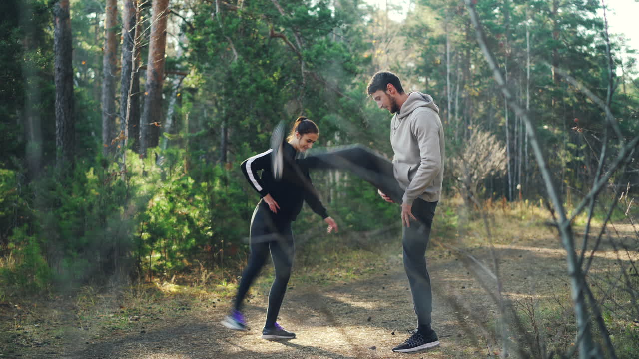 Couple exercising outdoors in a forest