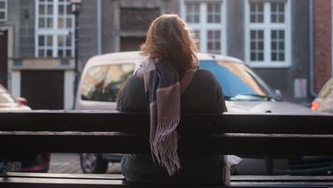 woman sitting on a bench in a city