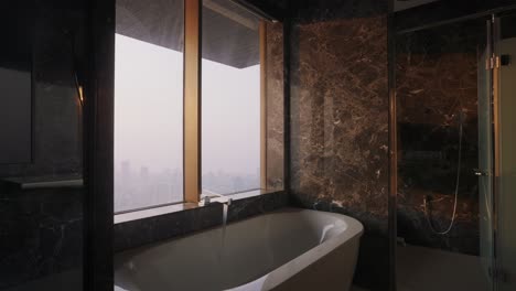 luxurious bathroom with white bathtub and elegant marble wall pattern design. - ascend shot