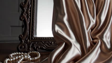 vintage mirror with satin drape and pearls