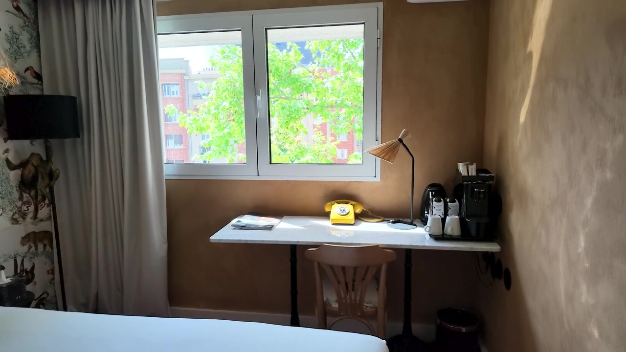 Cozy Hotel Room Interior with Desk and Vintage Telephone