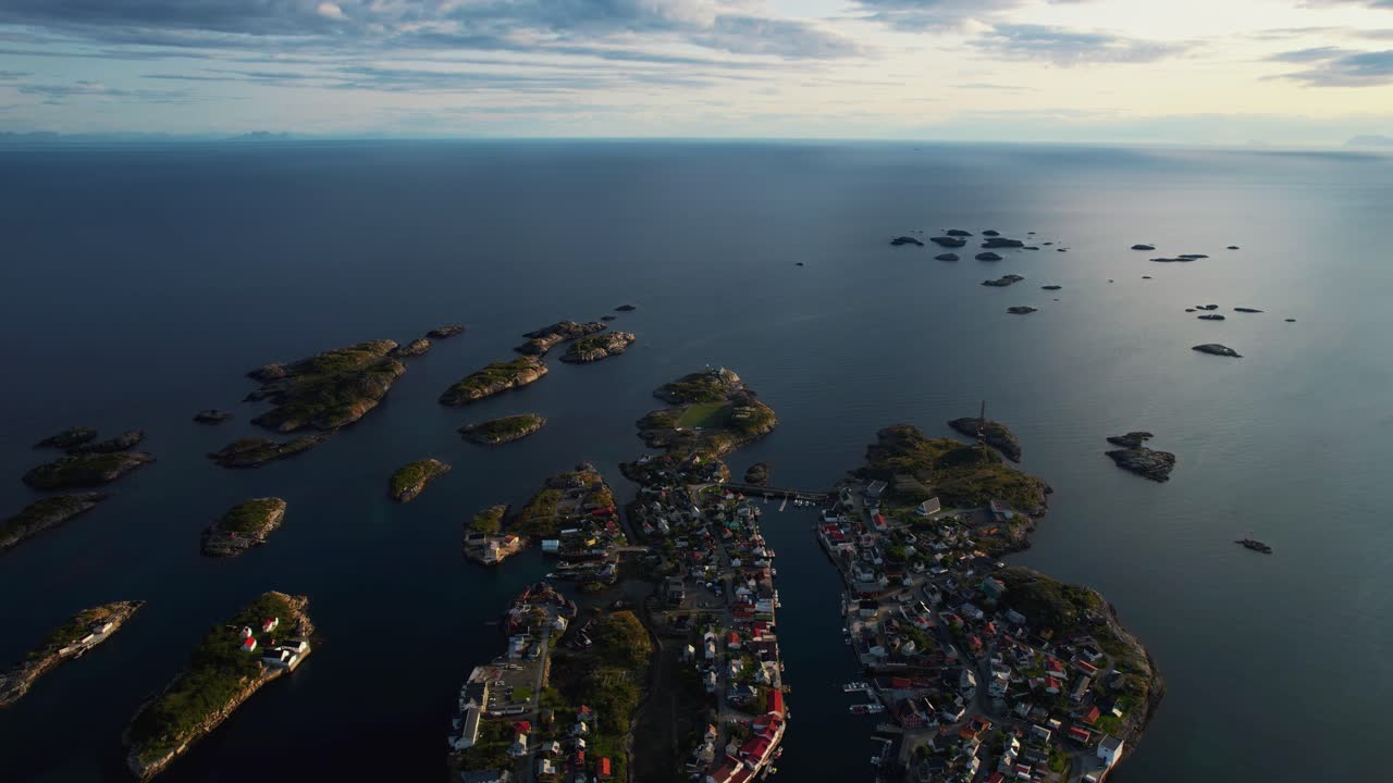 Coastal village Henningsvaer aerial with deep blue water and small islets on Lofoten islands, Norway