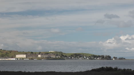 Boats-travel-past-a-beachfront-town