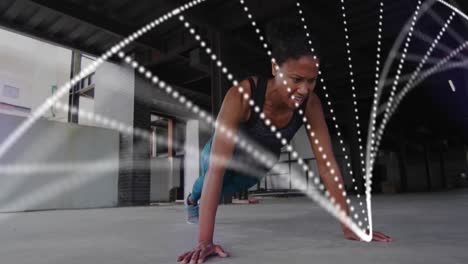 Animation-of-dna-strain-spinning-over-woman-exercising-in-an-abandoned-building