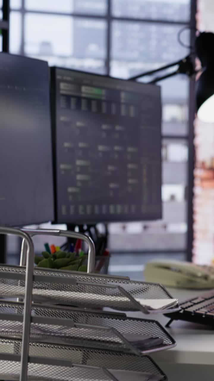 Vertical video PC screens in innovative startup office showing programming languages
