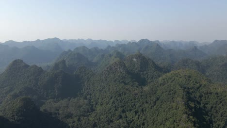 steep jagged mountain peaks, covered in dense green jungle, vietnam