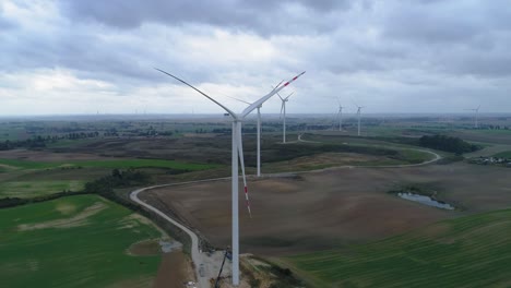 clouds over the wind turbines for generating renewable energy situated on the vast field in kwidzyn, pomeranian voivodeship, poland