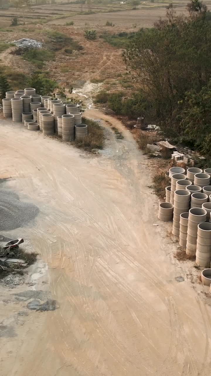 Stacks of concrete pipes in an industrial area