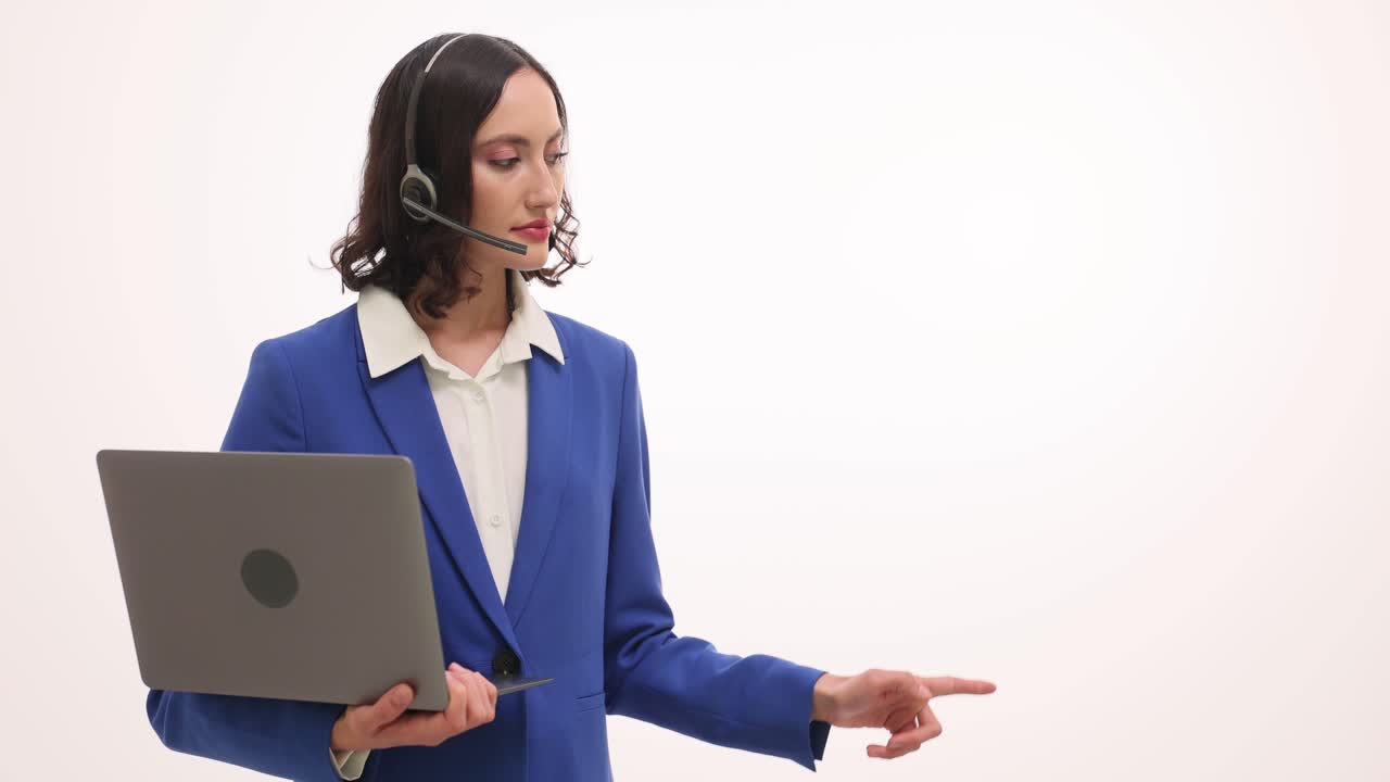 Businesswoman with laptop wearing headset presenting