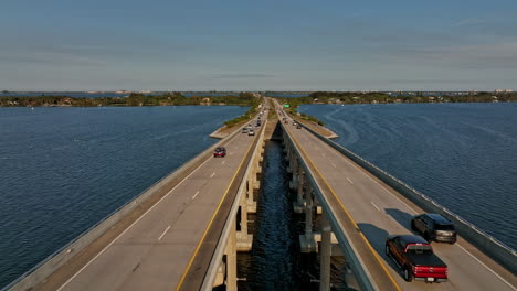 merritt island florida aerial v8 cinematic drone flyover indian river, flying straight above pineda causeway capturing commuters traffics on the road bridge - shot with mavic 3 cine - march 2022