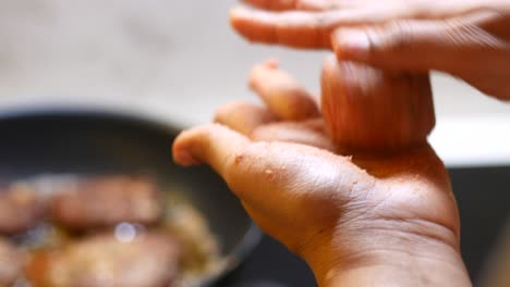 preparing meatballs in a pan