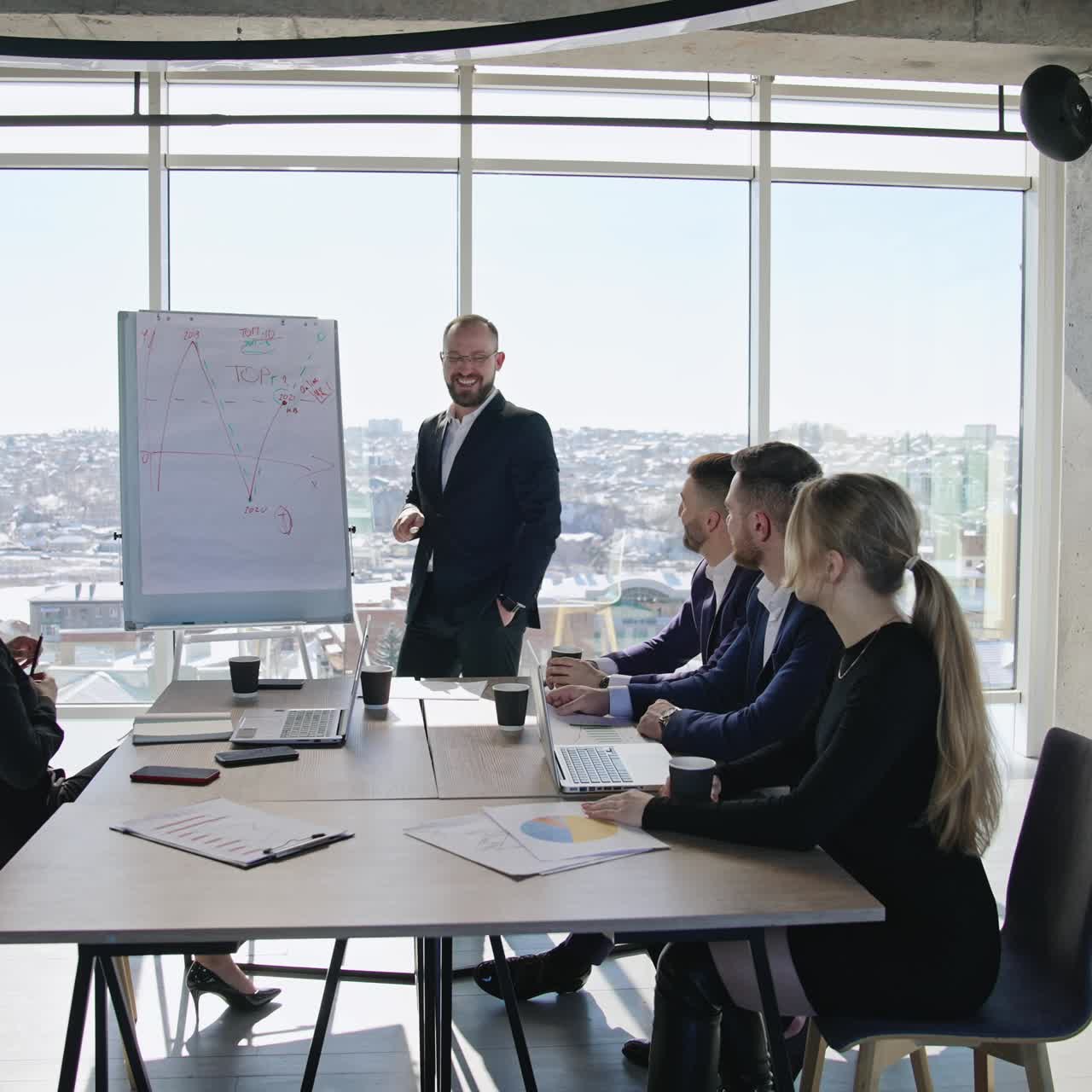 Successful business speaker performs a speech using a chart. Business communication among the coworkers in the office