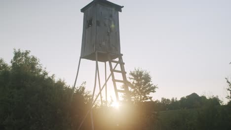 Wide-shot-of-a-deerstand-in-the-evening-with-backlight-from-the-sun