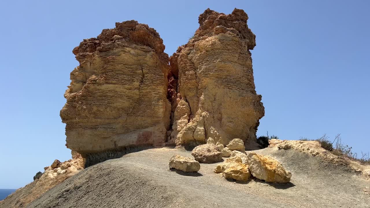 Hiking along Malta clay cliffs. Steep rock formation on Mediterranean island