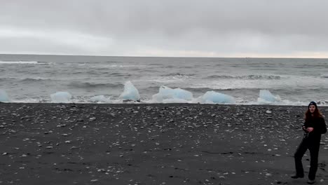 aerial shot of drone pilot on black sand beach