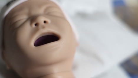 close-up of nursing school doll used to practice baby care