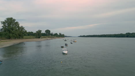 a few boats and rafts are moored on the banks of the danube