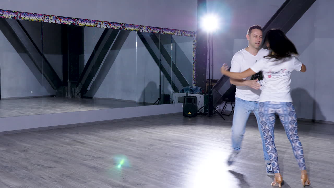 Dancing couple in a studio with mirrors