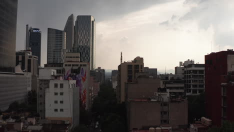 Slider-of-tall-office-buildings-in-city-downtown.-High-contrast-scene.-Sky-before-heavy-rain.-Mexico-City,-Mexico.