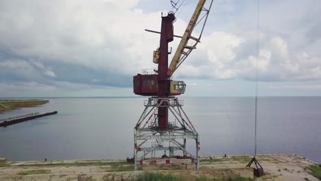 an old abandoned rusty crane in the seaport 03