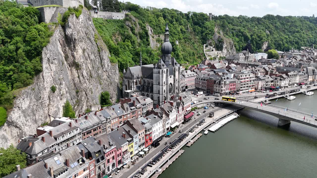 Pull back drone aerial reverse reveal Dinant city Belgium’s. on Meuse River waterfront