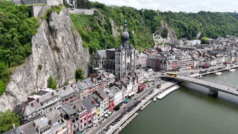 pull back drone aerial reverse reveal dinant city belgium’s. on meuse river waterfront