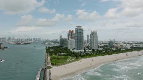 drone video over looking southbeach in miami florida seeing the miami skyline from afar