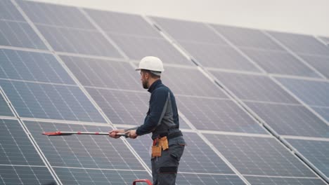 a general plan for the maintenance of a solar power plant by a young man in a working uniform