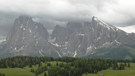 clouds over sassolungo mountain group peaks, italian dolomites