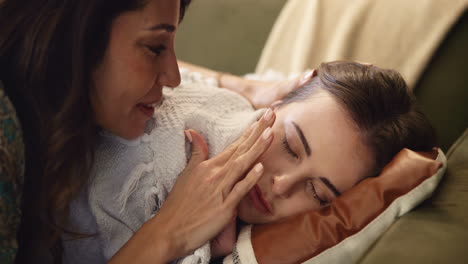 caring mother supporting sleeping daughter