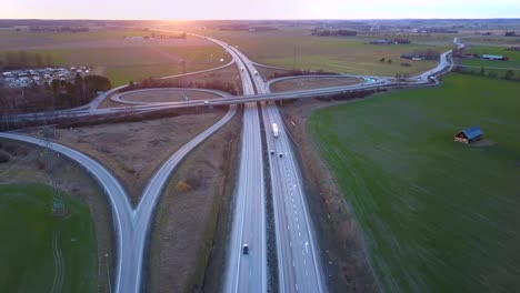 aerial view of freeway intersection with moving traffic cars.