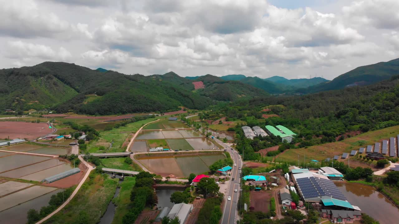 High altitude lateral slide takeover aerial view of solar power plant and country side