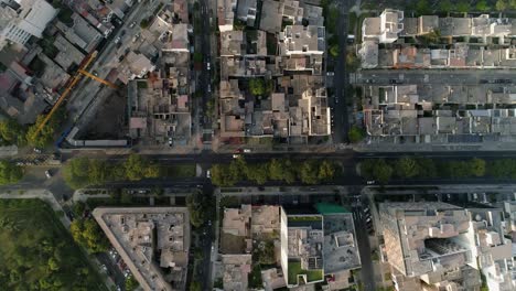 aerial view above quiet streets in the city of lima, sunset in peru - top down, drone shot