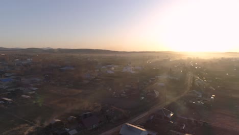 Flying-Over-Village-at-Sunset