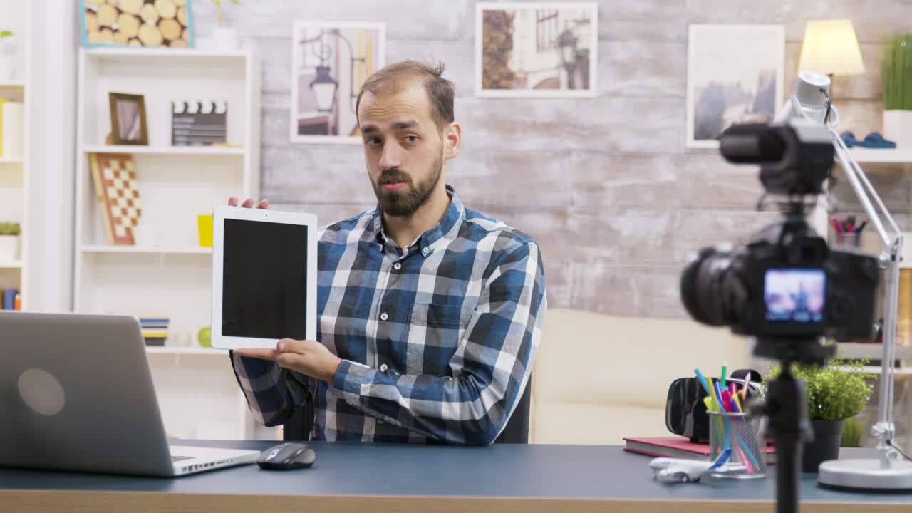 Man holding tablet in front of camera