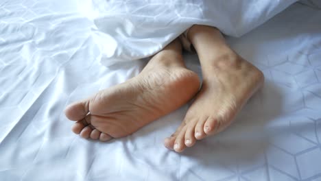 close up of a person's feet in a bed