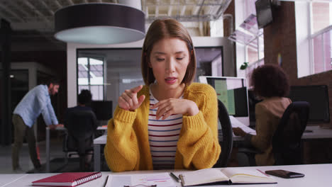 Happy-mixed-race-businesswoman-having-video-call-sitting-in-front-of-computer