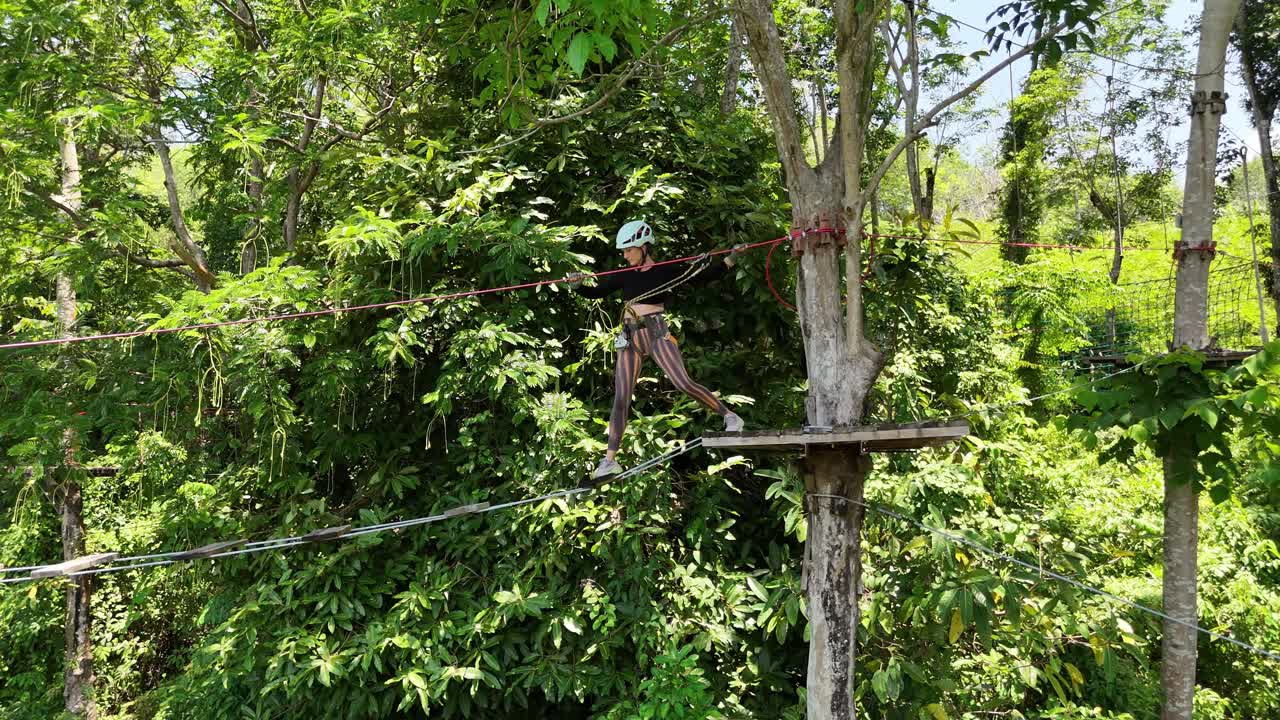 Woman ziplining through the forest canopy