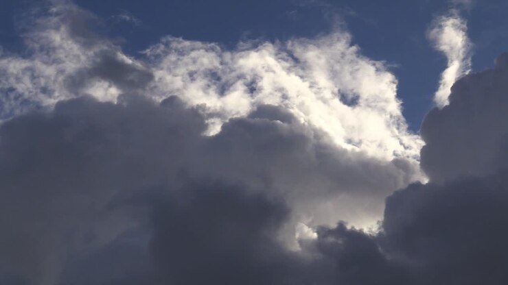 Irish clouds moving in the sky from a distance on a sunny day.