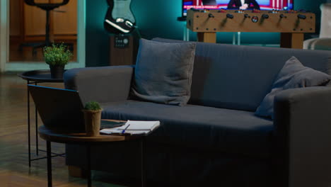 stylish empty apartment loft with a comfortable couch and smart tv in the living room, modern space with decorations and funky neon lights. studio with a coffee table and home theatre setup.
