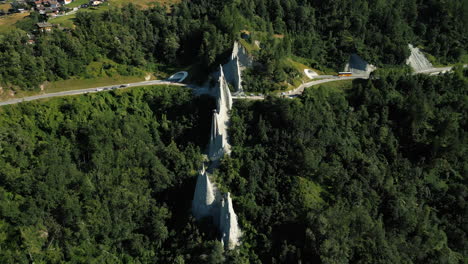 aerial: fairy chimney rock formations during the day in euseigne, canton of valais, switzerland, orbit drone shot