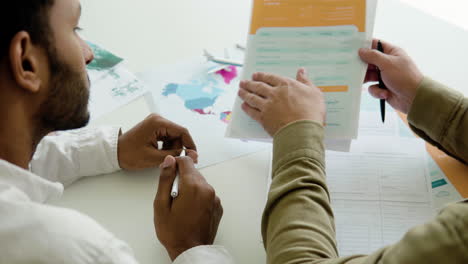 man working with client in a travel agency