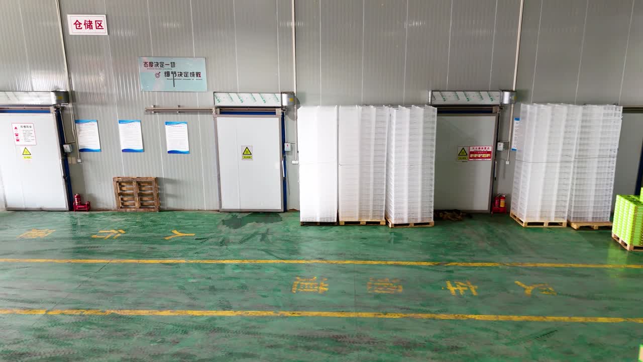 Drone view inside a kiwi factory in Shaanxi Province, China, showcasing the cooling storage rooms designed for optimal fruit preservation and efficient storage practices.