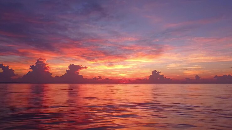 Serene Sunset Over Calm Ocean Waters Captured in Stunning Vibrant Colors, Reflecting a Peaceful Moment of Nature's Beauty and Tranquility.