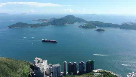 Mega-Container-Ship-leaving-Hong-Kong-bay,-Aerial-view